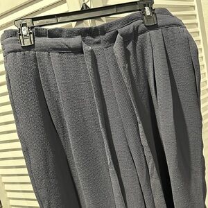 Black dress pants with attached belt.